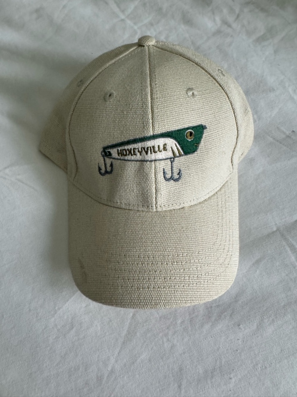 Cream “Hoxeyville” Baseball Cap with Green & Navy Embroidered Lure